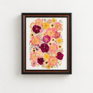 Custom 20x28 walnut wood frame featuring a colorful arrangement of pressed wedding flowers in shades of pink, coral, burgundy, yellow, and ivory, thoughtfully designed by Forgiven Flower.