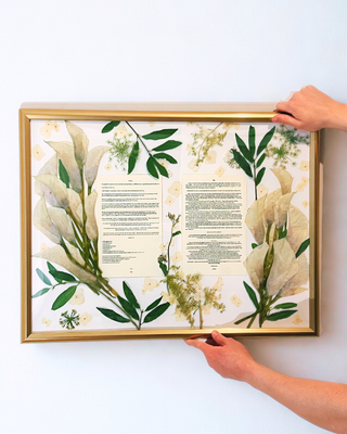 Custom pressed flower keepsake framing wedding stationery and wedding vows with preserved greenery and flowers.