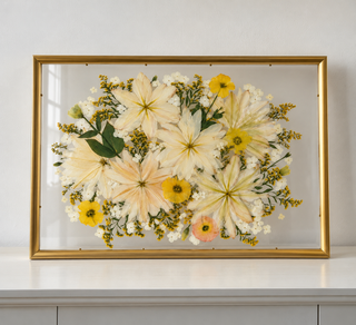 Pressed yellow and white florals in a 20x28 gold float frame. 
