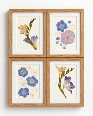 Set of four custom 5x7 light oak frames featuring individually pressed wedding flowers in blue, lavender, cream, and pale yellow, arranged as matching floral keepsakes by Forgiven Flower.