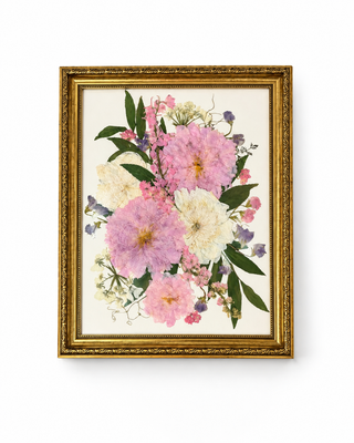Custom pressed wedding bouquet featuring pink, ivory, and purple flowers with greenery in an ornate vintage gold 11x14 frame by Forgiven Flower.