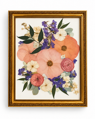 Custom pressed wedding bouquet featuring peach, coral, dusty pink, purple, and ivory flowers with green foliage in an ornate vintage gold frame by Forgiven Flower.