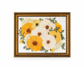 Custom pressed wedding bouquet featuring golden yellow, ivory, and pale yellow flowers with greenery in an ornate vintage gold frame by Forgiven Flower.