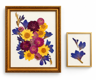 Custom pressed wedding bouquet featuring yellow, magenta, burgundy, and blue flowers in an ornate vintage gold frame, displayed alongside a smaller gold frame with preserved blue flowers by Forgiven Flower.