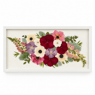 Pressed wedding bouquet featuring burgundy, blush pink, lavender, and ivory flowers arranged in a white frame with greenery by Forgiven Flower.