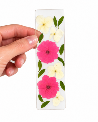 Close-up of handmade pressed flower bookmark with delicate preserved blooms