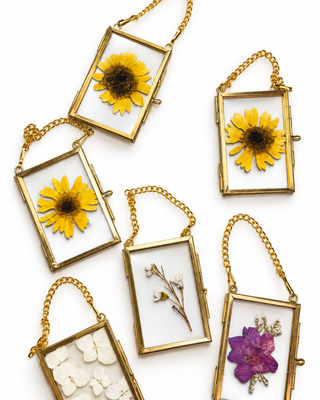 custom pressed flower christmas ornaments made with either pressed funeral flowers, pressed wedding flowers, or any special event flowers. 